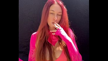 Artemisia Love Smoking a Cigarette Outdoors